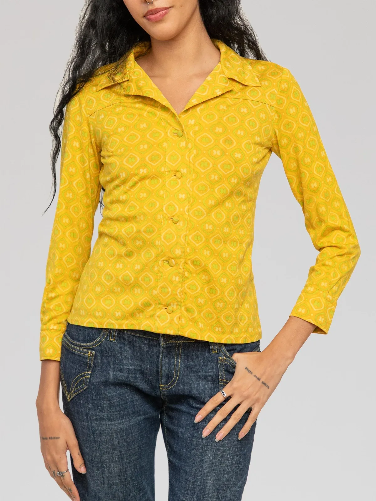 Christian Dior long-sleeve geometric print shirt rendered in a vibrant mustard yellow with lime green and white retro tile motifs, featuring a wide pointed collar, covered front button closures, subtle yoke detailing across the chest and back, and single-button barrel cuffs.