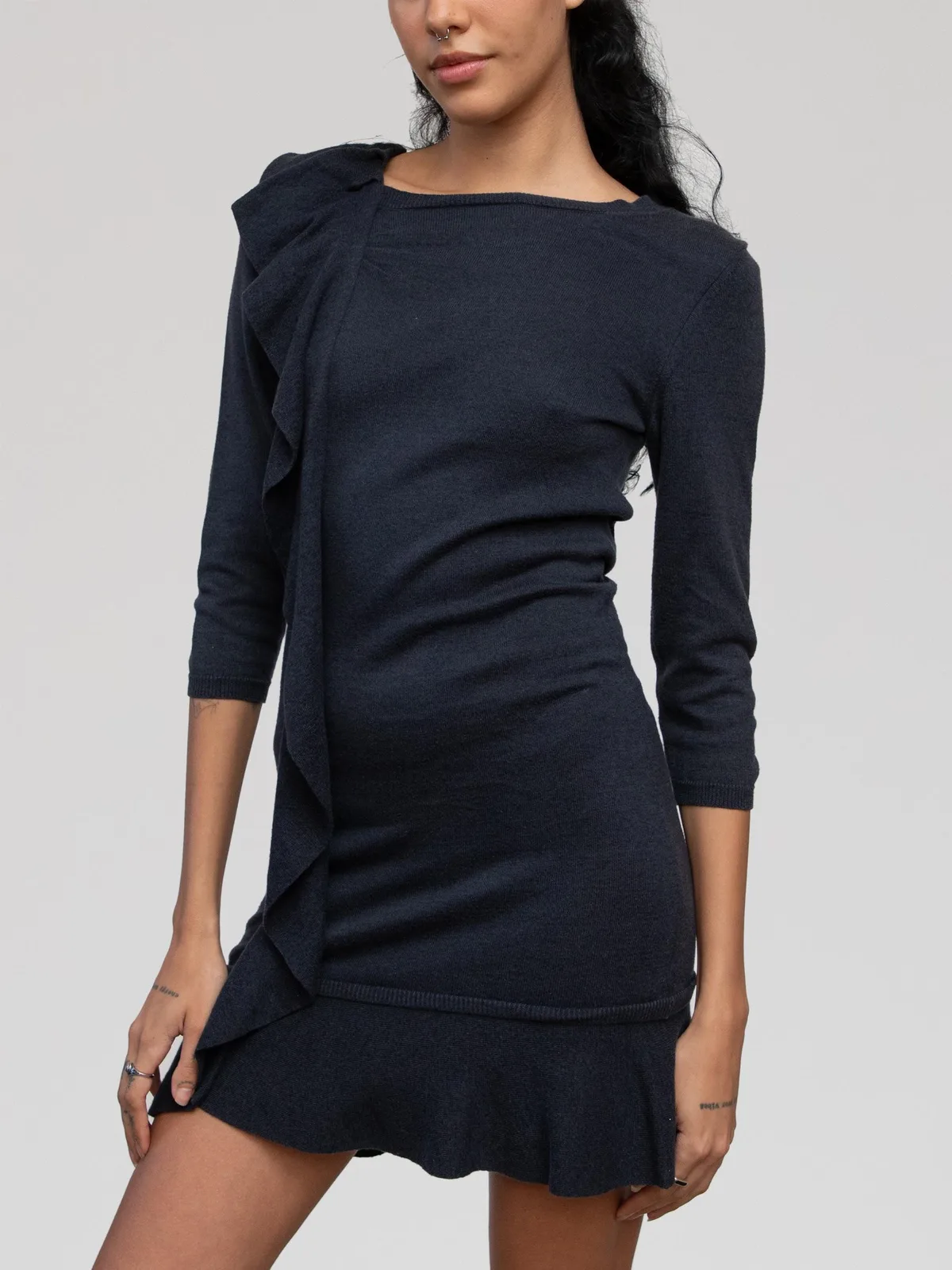 Valentino charcoal grey fine-knit mini dress featuring 3/4-length sleeves, a boat neckline, a vertical cascade ruffle along the right side, and a ruffled drop-waist flounce hem.