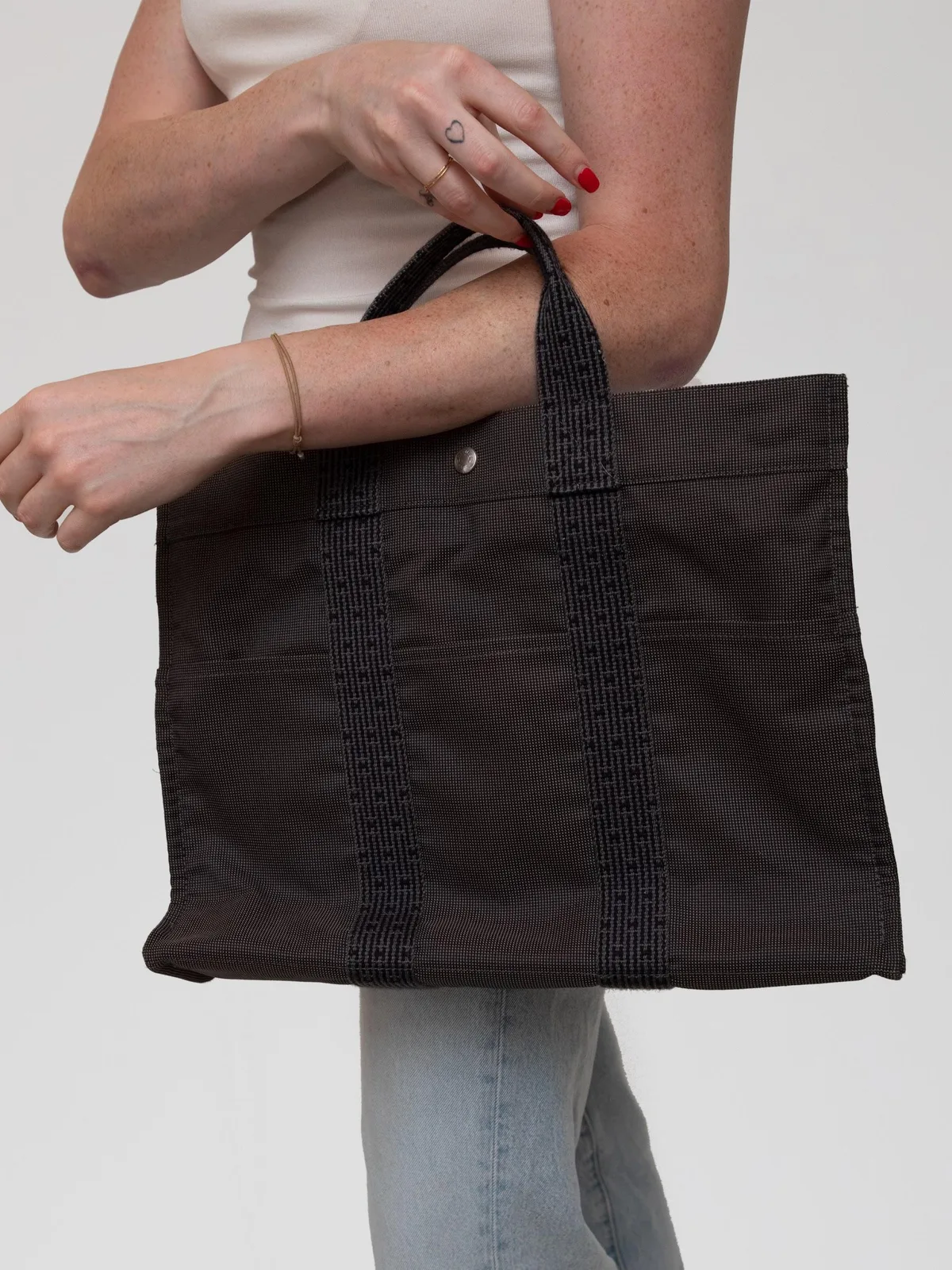 Woven from durable canvas with signature Hermès webbing handles, this classic Fourre-Tout MM tote marries Parisian utilitarian style with understated luxury for effortless everyday function.