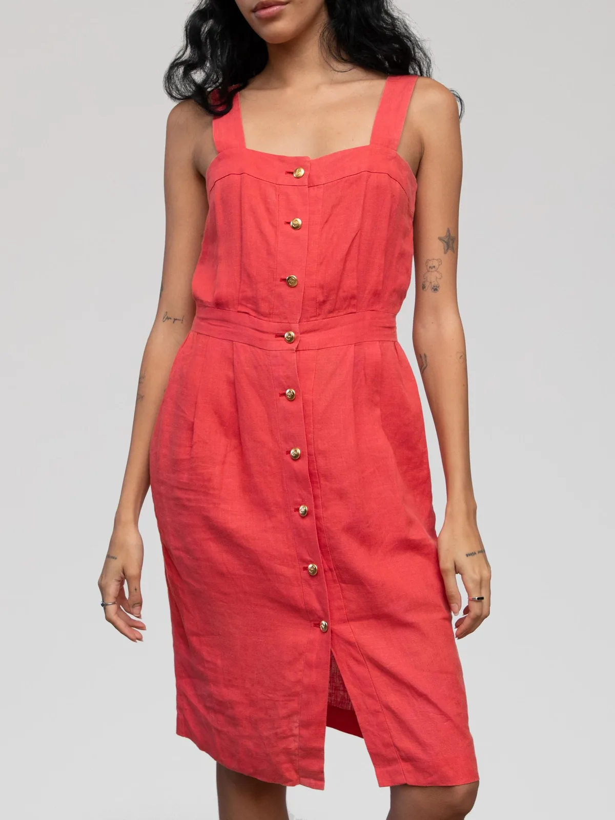 Christian Dior coral red linen sun dress featuring thick tank straps, a square neckline, a tailored fitted bodice with pleating, a defined waist, gold-tone front button-down closures, and a knee-length sheath skirt with a front hem slit.